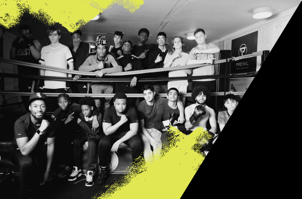 A group of young people at a Be Inspired event, standing in a boxing ring.